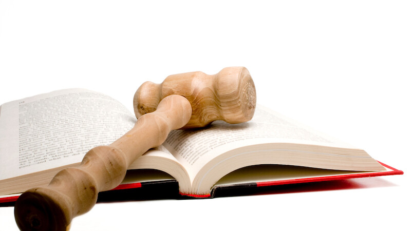 A gavel is placed on top of an open book