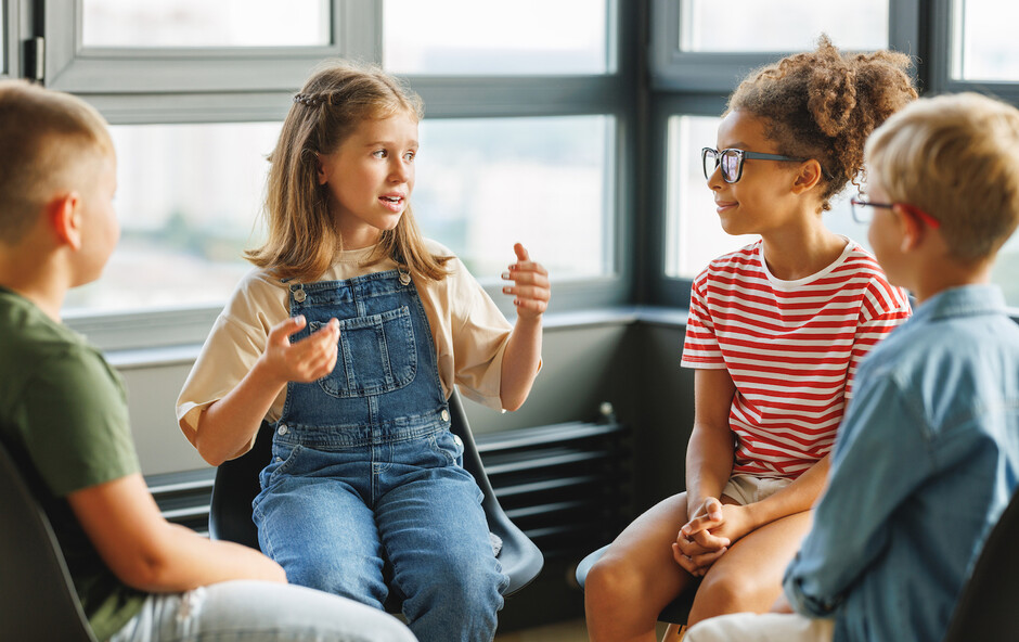 Illustration photo of young pupils talking together in a group.