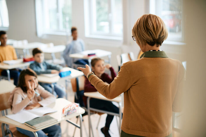 Illustration image of teacher in a classroom with pupils