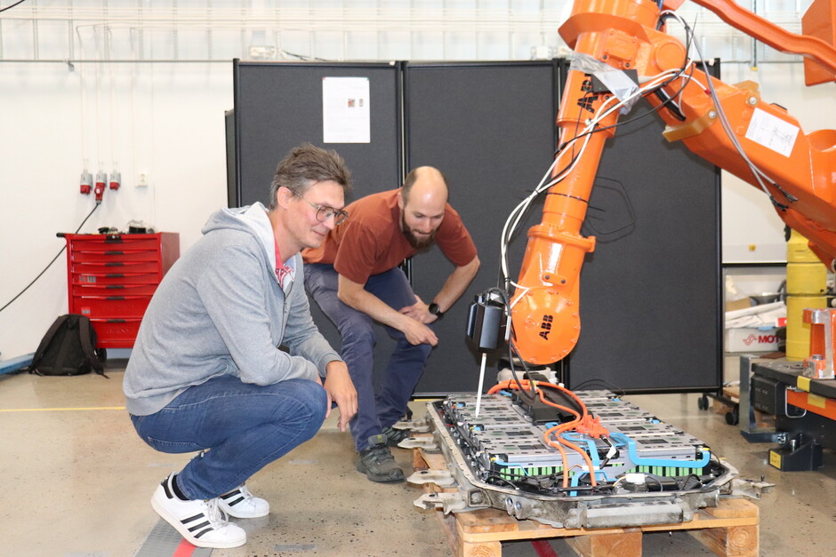 Photo shows researchers check the robot gripper.