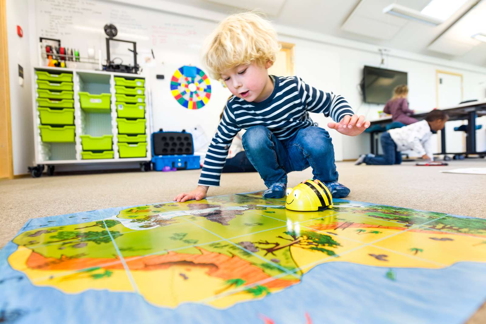 young person playing a learning game on the floor