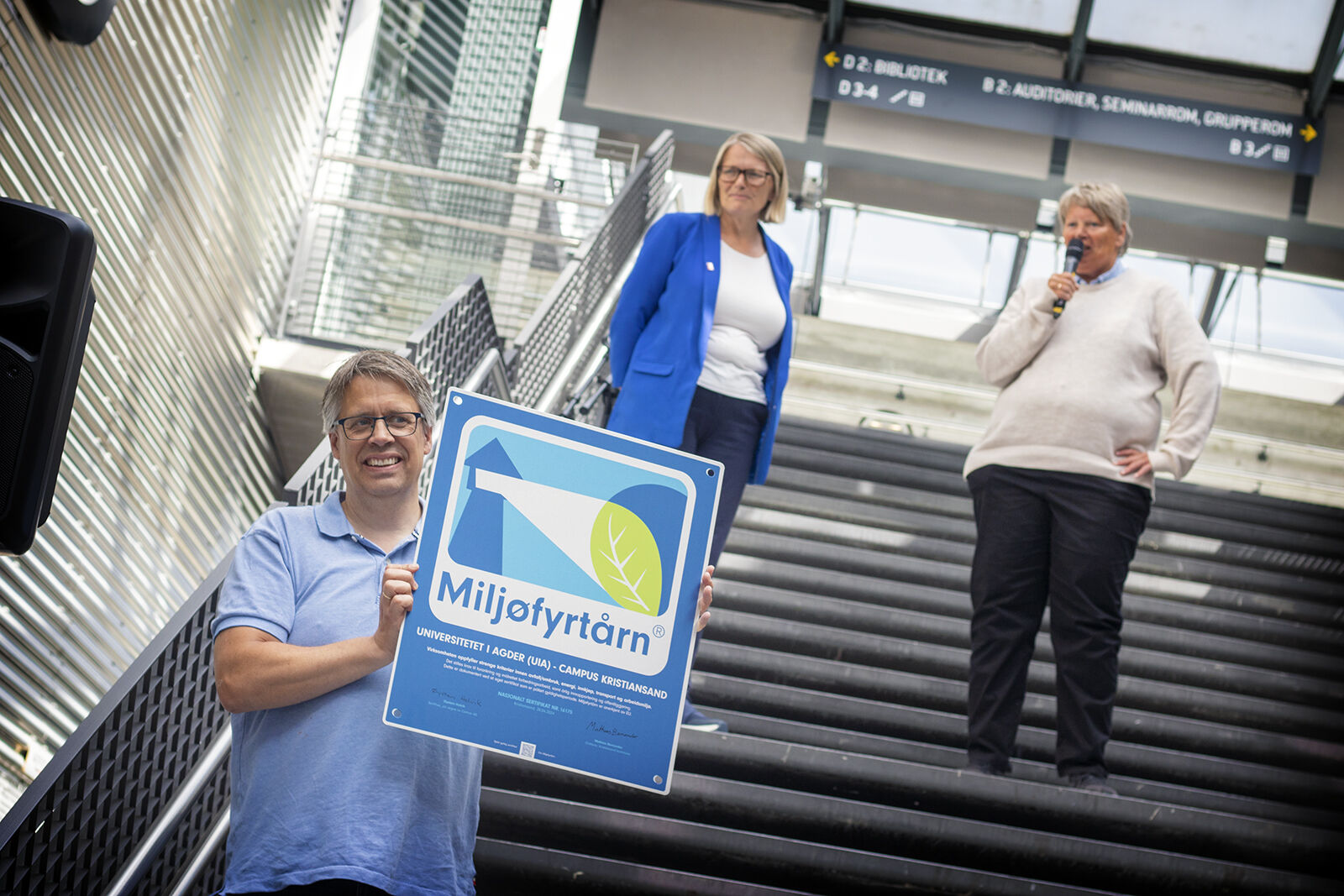 Photo shows Kjetil Hellang holding an Eco-Lighthouse certification sign