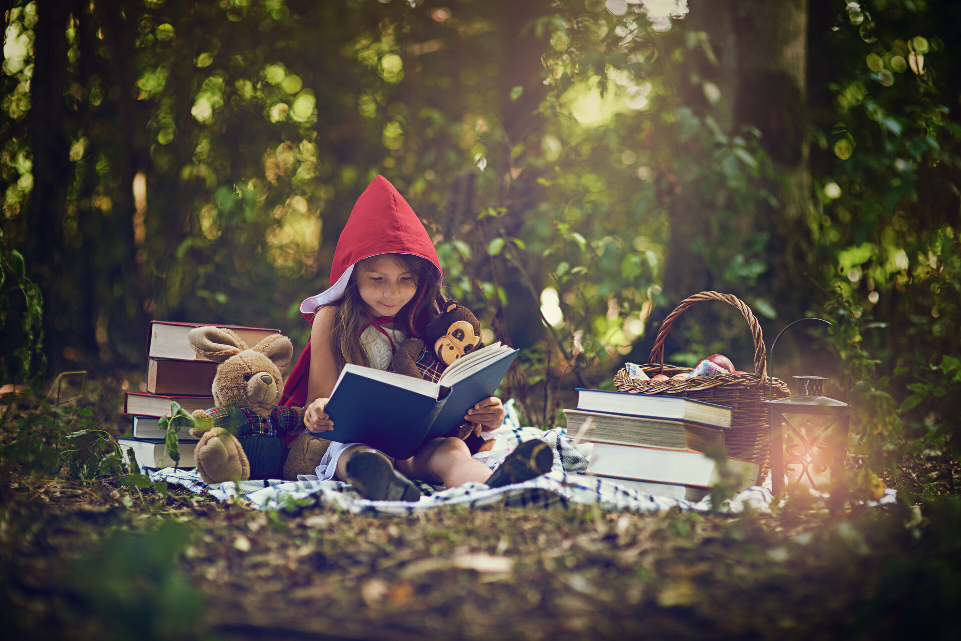 Barn leser bok i skogen